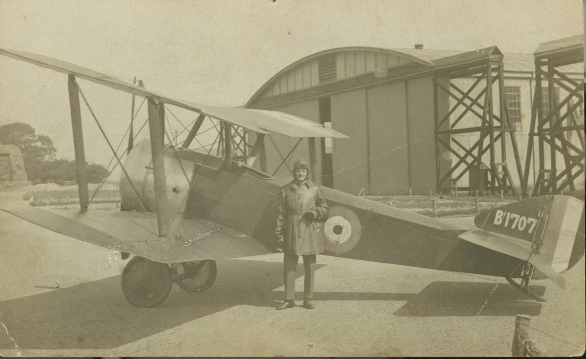 Captain Collett stands beside a Sopwith Pup outside a hangar. Collett flew extensively during May, June and July, 1917.